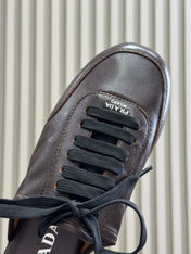 PRADA 25S COLLAPSE MULES IN DARK BROWN CALFSKIN