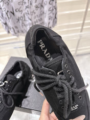 PRADA 26S COLLAPSE SNEAKERS IN BLACK CANVAS