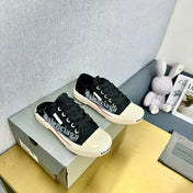 SNEAKER MULES IN BLACK CANVAS GRAFFITI LOGO
