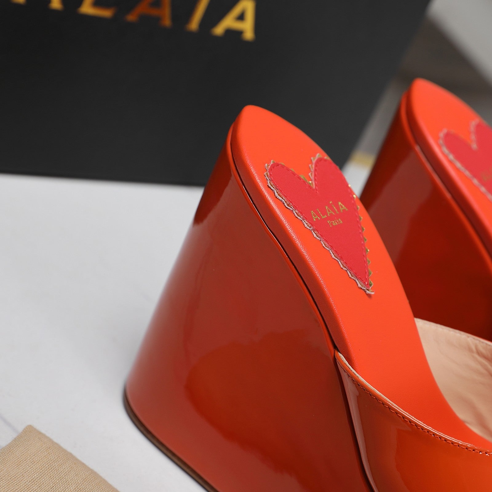 ALAIA PLATFORM WEDGE IN VIVID ORANGE LAMBSKIN WITH RED HEART