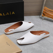 ALAIA FLAT MULE IN WHITE LAMBSKIN