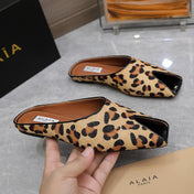 ALAIA FLAT MULE IN LEOPARD LAMBSKIN