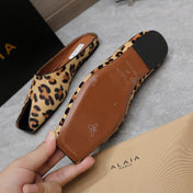 ALAIA FLAT MULE IN LEOPARD LAMBSKIN