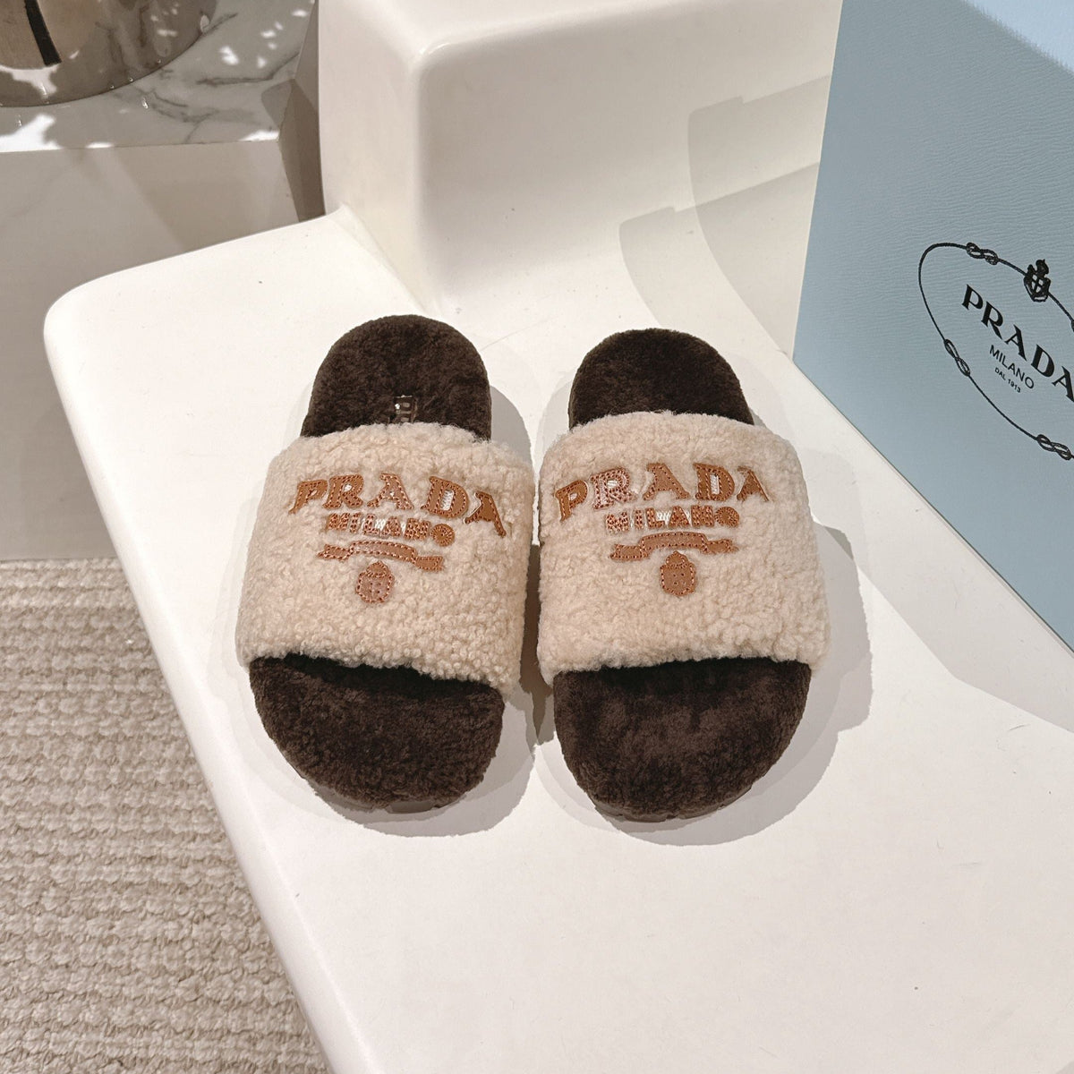 PRADA 25S FLAT MULES IN CREAM AND DARK BROWN RABBIT FUR