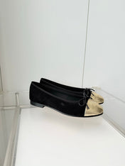 CHANEL 26S BALLET FLATS IN BLACK SUEDE WITH GOLD TOE CAP AND BOW