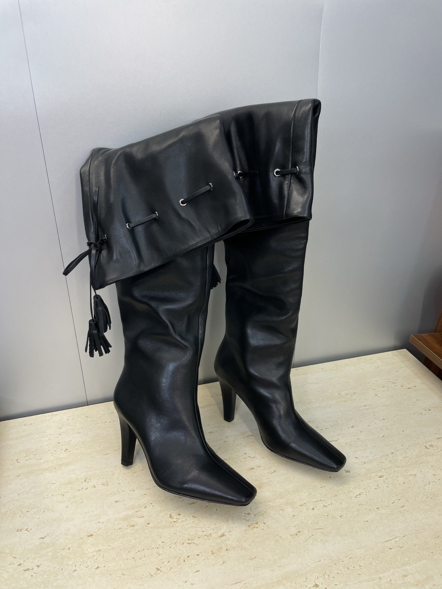 YSL 25S HIGH‑HEEL FRINGED MARTIN BOOTS 90 MM IN BLACK LAMBSKIN