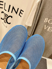 ALAIA FLAT MULES IN CERULEAN BLUE MESH FISHNET