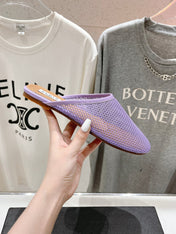 ALAIA FLAT MULES IN LIGHT PURPLE MESH FISHNET